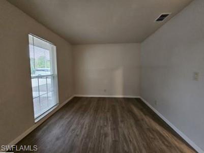 3005 Gordon Street Naples, FL 34112 - Photo 9 of 11 Unfurnished room featuring baseboards and dark wood-style flooring