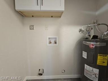 3005 Gordon Street Naples, FL 34112 - Photo 10 of 11 Laundry room featuring electric water heater, cabinet space, gas dryer hookup, and washer hookup