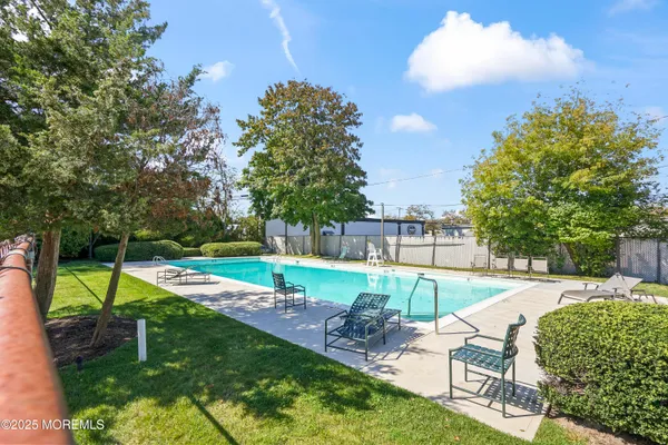 a view of a backyard with swimming pool