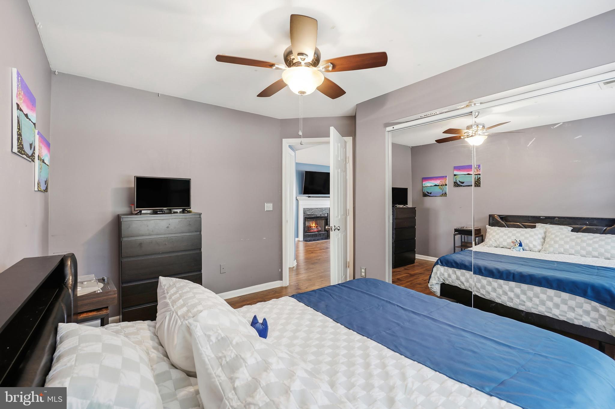14151 Cuddy Loop, Unit 101 Woodbridge, VA 22193 - Photo 15 of 45 a bedroom with a bed and a chandelier