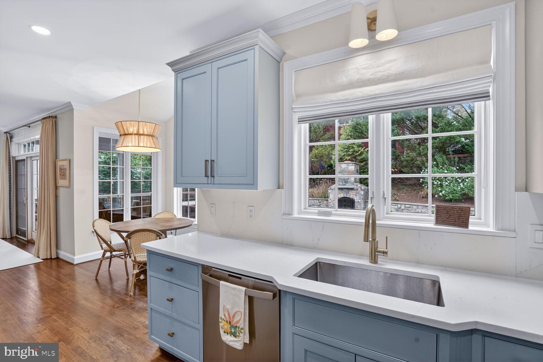 4837 W Street Northwest Washington, DC 20007 - Photo 13 of 51 a kitchen that has a sink and a large window with wooden floor