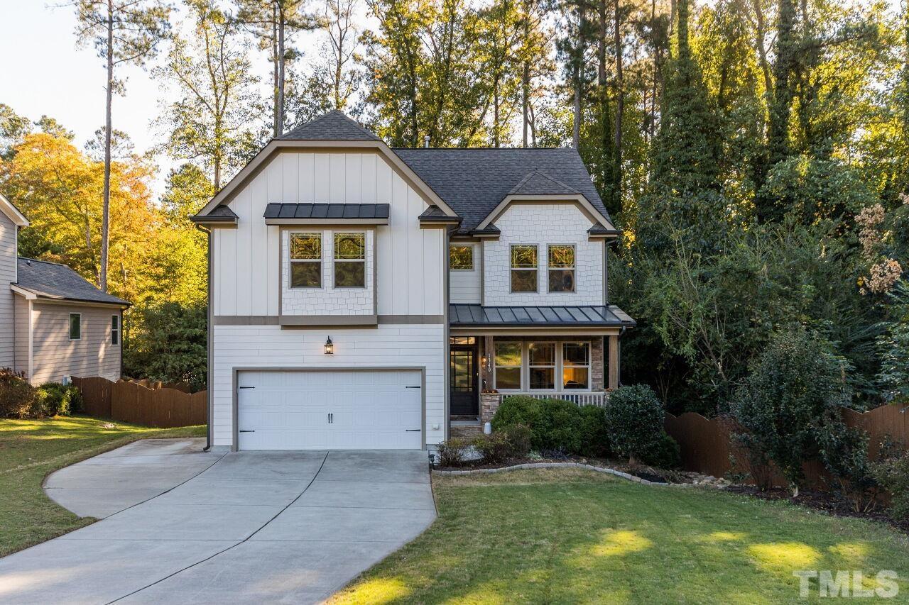 1340 Trinity Road Cary, NC 27513 - Photo 1 of 30 a front view of a house with a yard and garage