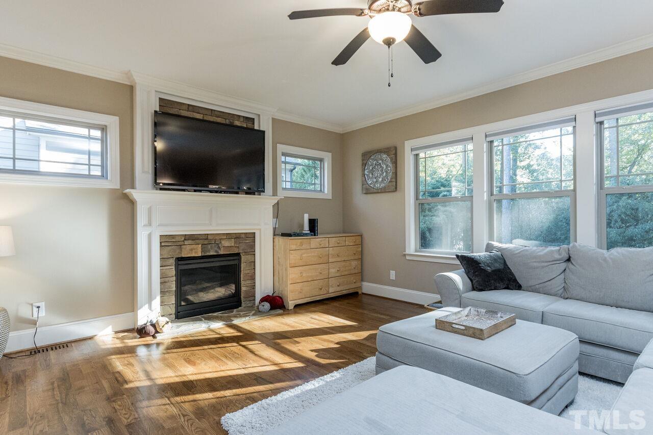 1340 Trinity Road Cary, NC 27513 - Photo 11 of 30 a living room with furniture a flat screen tv and a fireplace