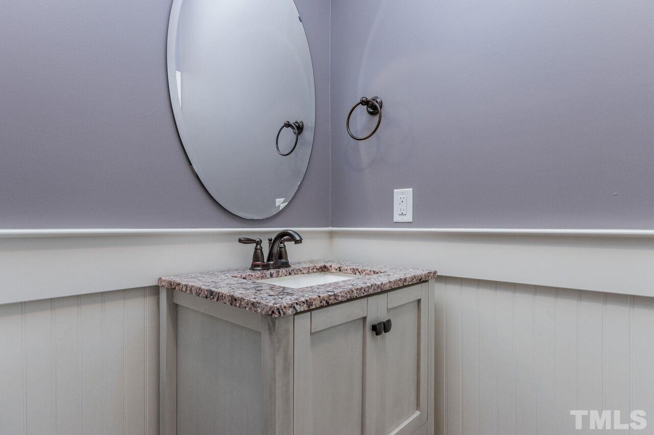 1340 Trinity Road Cary, NC 27513 - Photo 14 of 30 a bathroom with a sink and a mirror