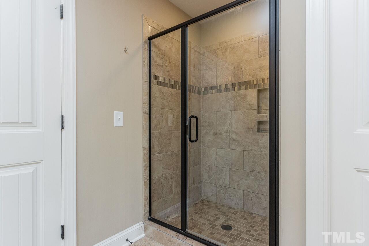 1340 Trinity Road Cary, NC 27513 - Photo 19 of 30 a bathroom with a glass shower door
