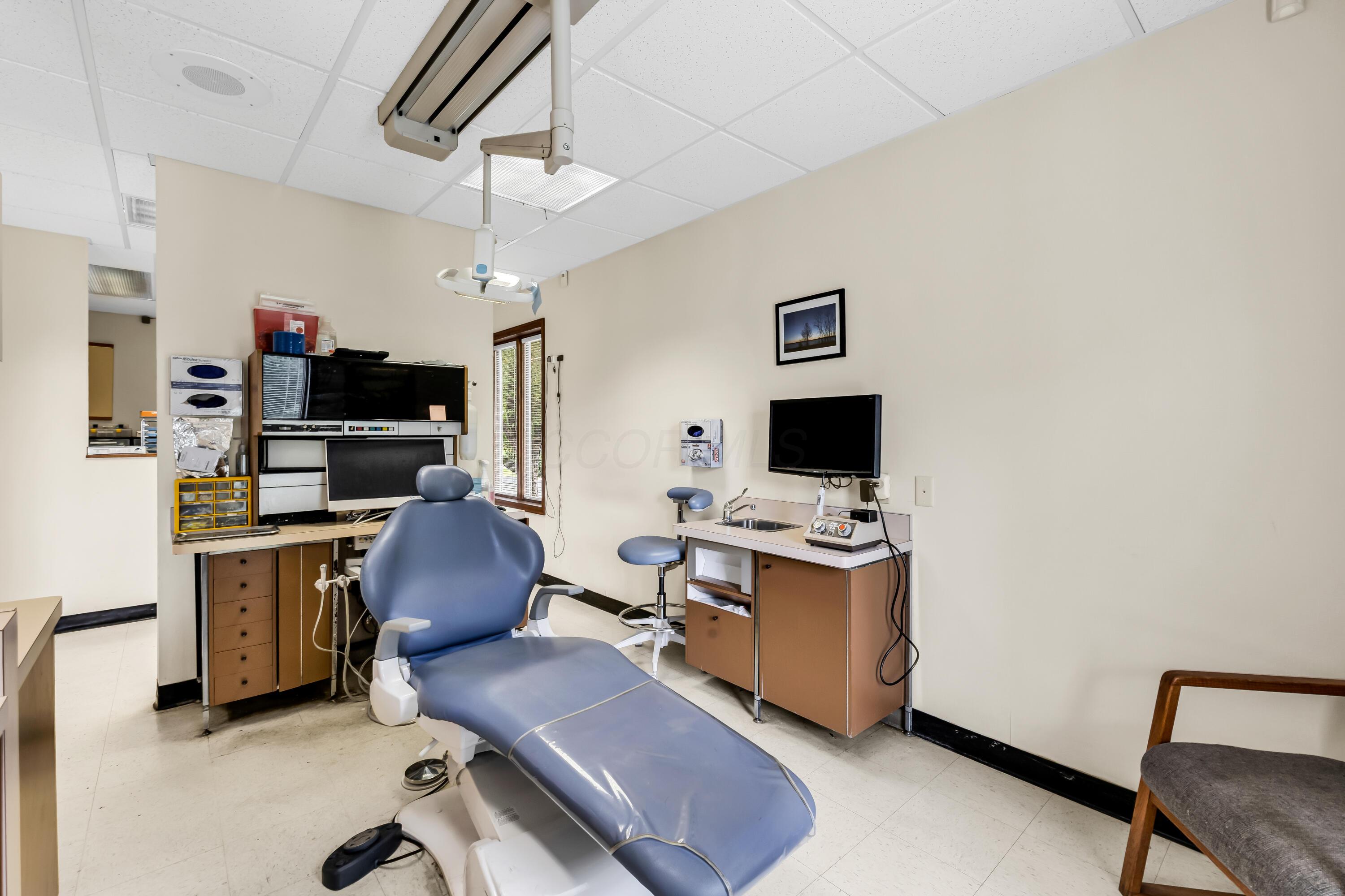 1240 Crescent Heights Road Marion, OH 43302 - Photo 35 of 60 • Neutral vinyl flooring • Ivory painted walls • Acoustic ceiling tiles • Fluorescent lighting • Enclosed vanity with single bowl, stainles steel sinktop • Divider • Lighting & equipment do not remain • Plumbed for oxygen & nitrogen