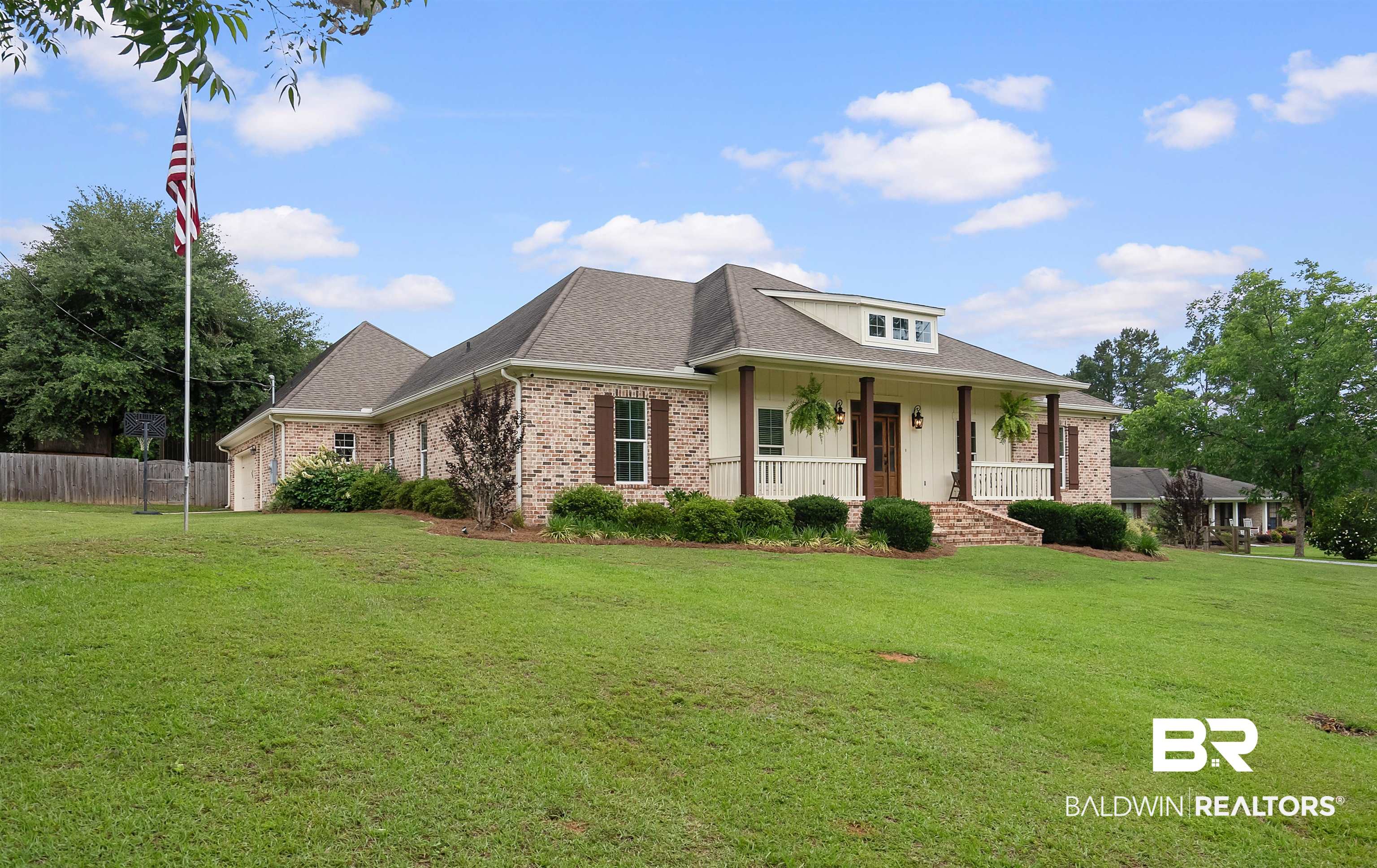 12070 Comalander Road Fairhope, AL 36532 - Photo 50 of 50 Brick exterior with white siding accents and a covered front porch featuring white railings