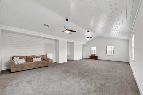 an empty room with windows and cabinet