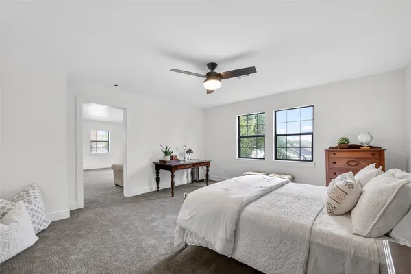 a bedroom with a bed and a chandelier