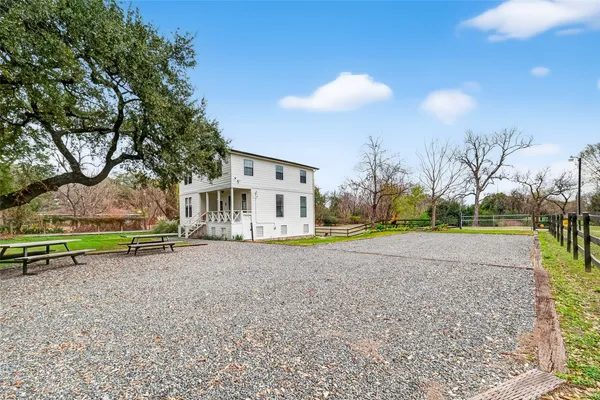 a view of a house with a yard and sitting area