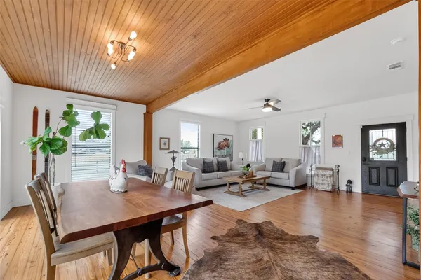a dining room with furniture window and wooden floor