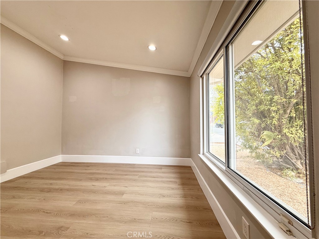 24204 Calvert Street Woodland Hills, CA 91367 - Photo 30 of 70 a view of an empty room with wooden floor and a window