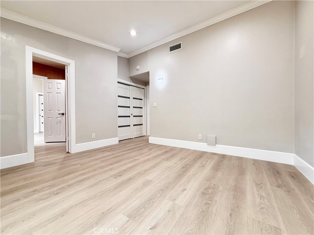 24204 Calvert Street Woodland Hills, CA 91367 - Photo 31 of 70 a view of wooden floor and windows in a room