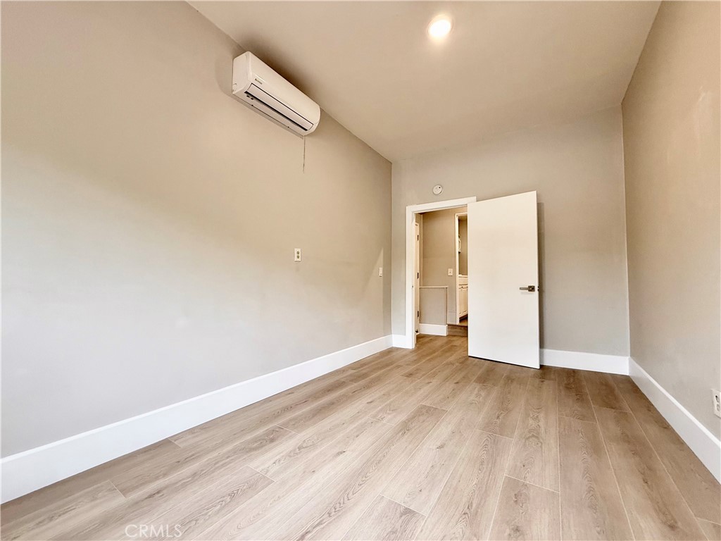 24204 Calvert Street Woodland Hills, CA 91367 - Photo 40 of 70 a view of an empty room with wooden floor and a window