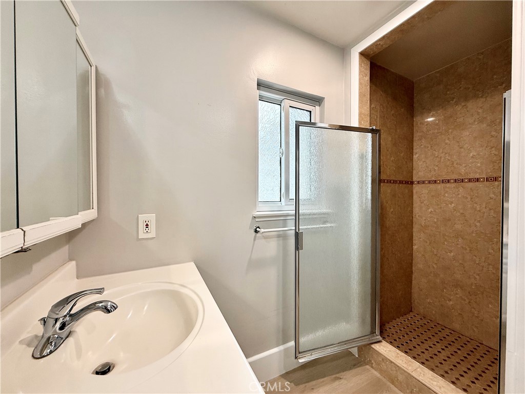 24204 Calvert Street Woodland Hills, CA 91367 - Photo 42 of 70 a bathroom with a sink and a shower
