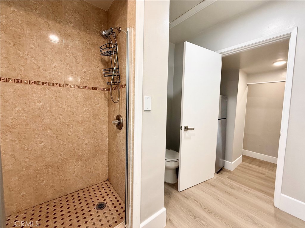 24204 Calvert Street Woodland Hills, CA 91367 - Photo 43 of 70 a bathroom with a shower and a toilet