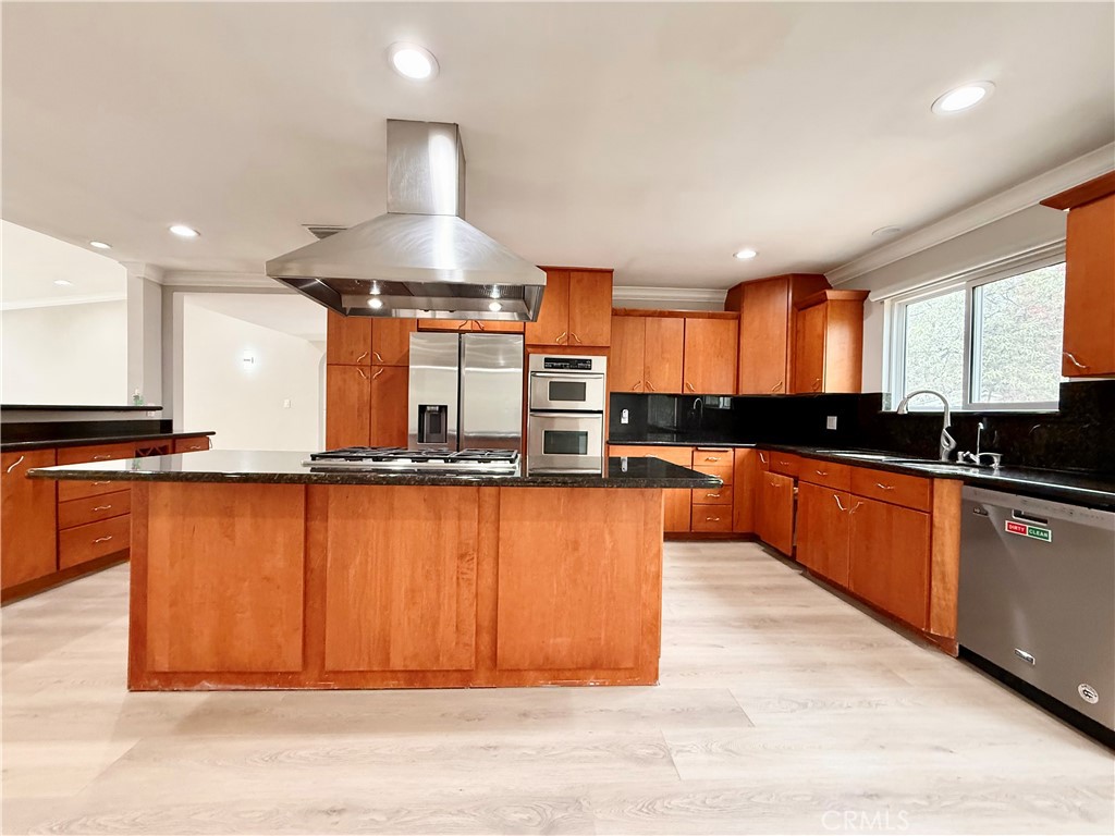 24204 Calvert Street Woodland Hills, CA 91367 - Photo 60 of 70 a kitchen with stainless steel appliances granite countertop a stove a sink and a refrigerator