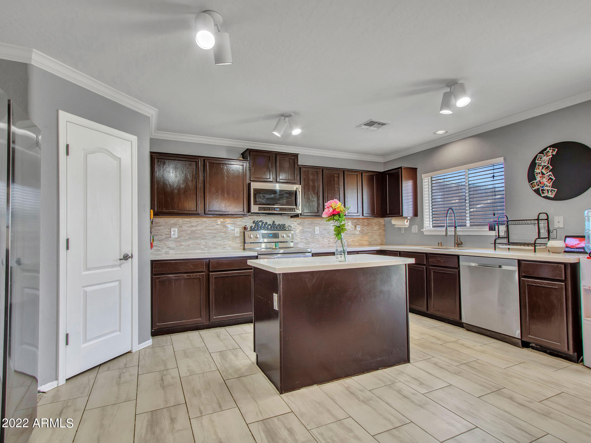 11645 West Mountain View Road Youngtown, AZ 85363 - Photo 13 of 45 a kitchen with stainless steel appliances granite countertop a stove sink and cabinets
