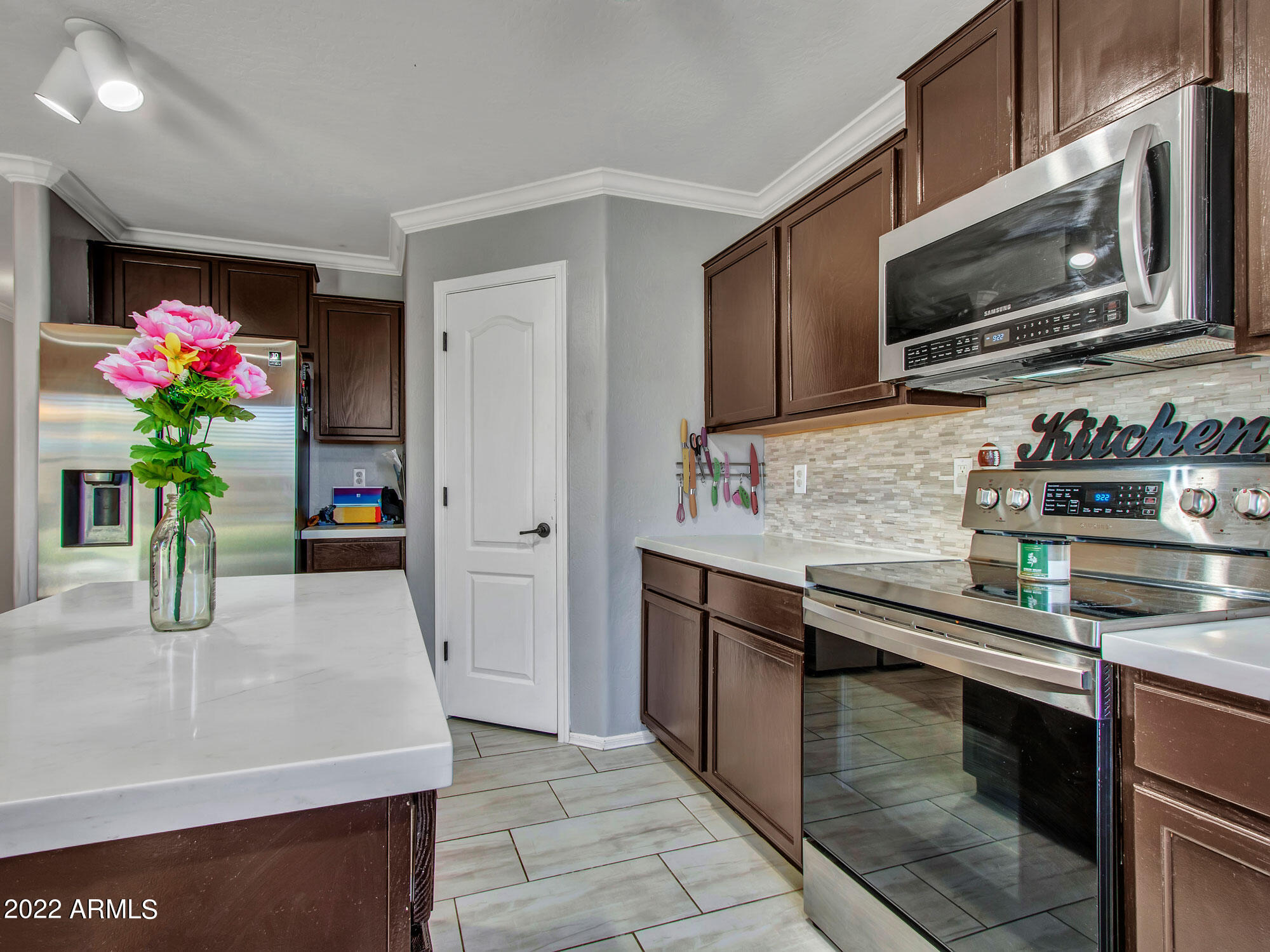 11645 West Mountain View Road Youngtown, AZ 85363 - Photo 16 of 45 a kitchen with stainless steel appliances granite countertop a sink and a stove