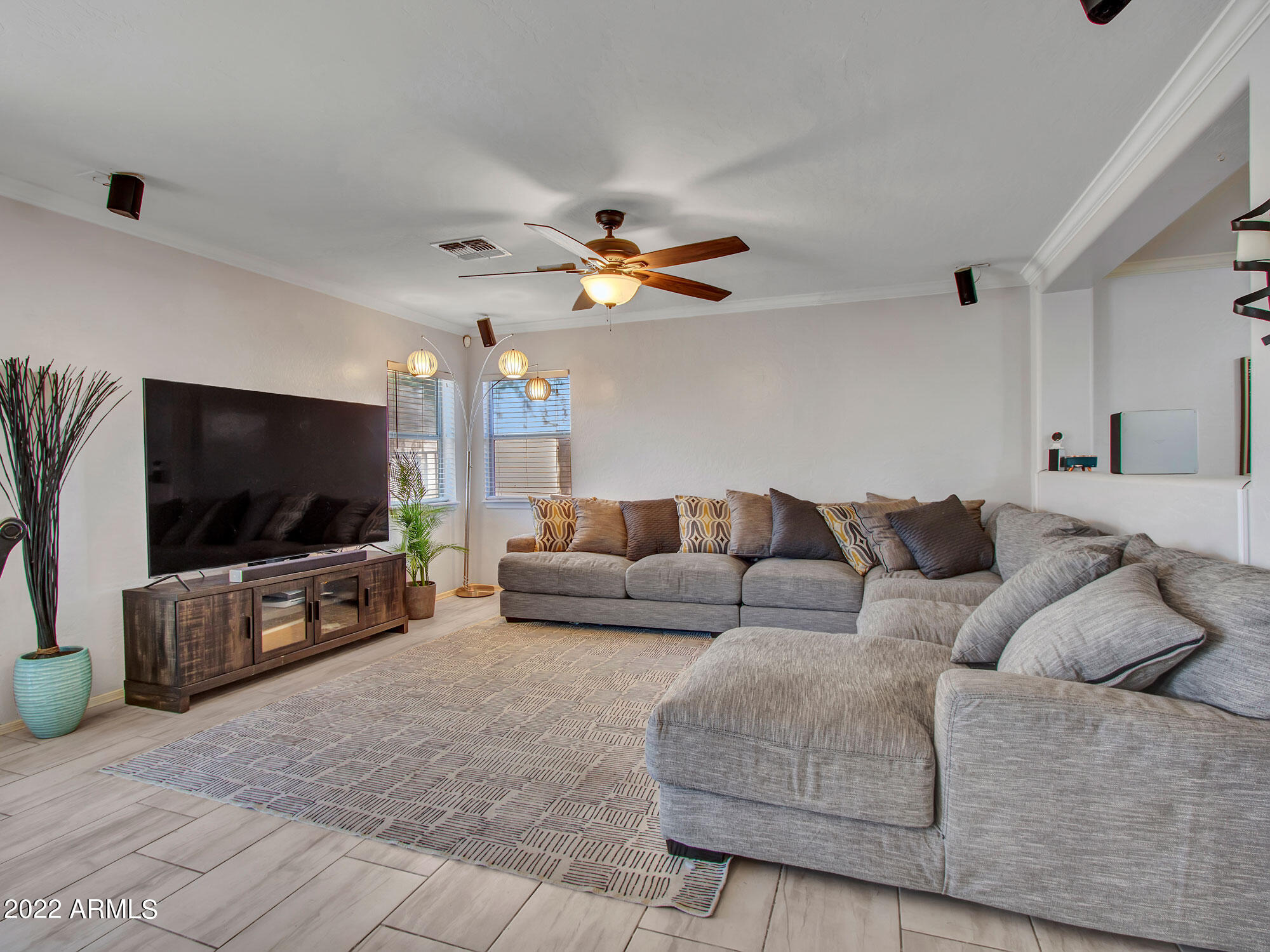 11645 West Mountain View Road Youngtown, AZ 85363 - Photo 18 of 45 a living room with furniture and a flat screen tv