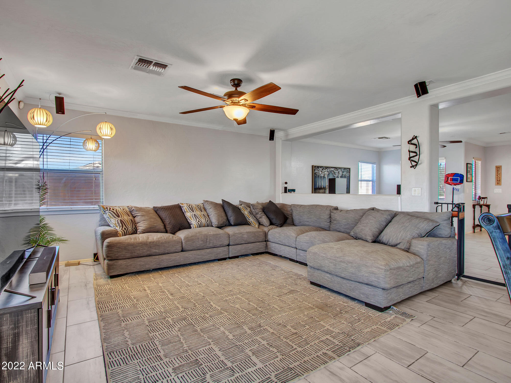 11645 West Mountain View Road Youngtown, AZ 85363 - Photo 19 of 45 a living room with furniture and a chandelier
