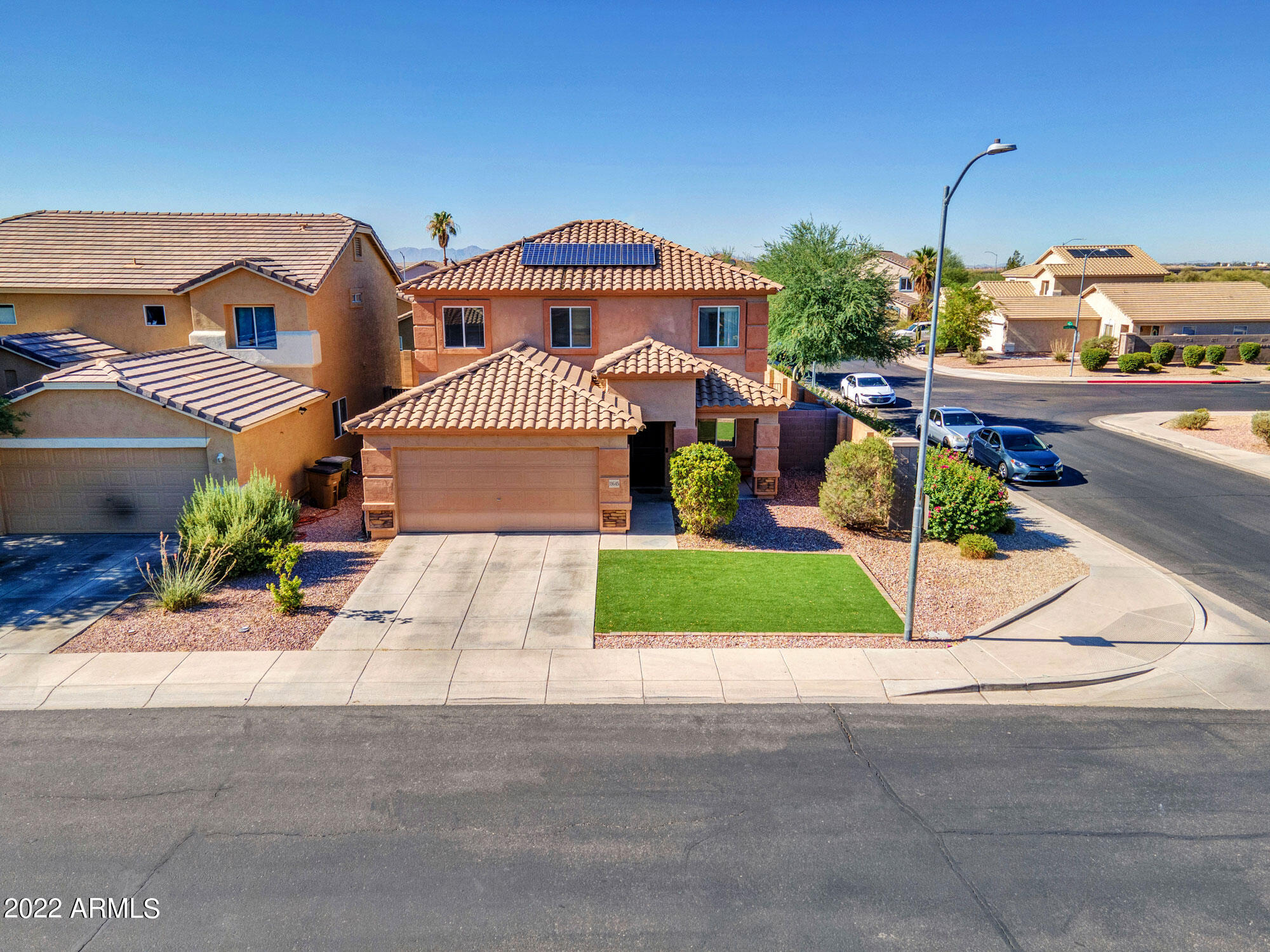 11645 West Mountain View Road Youngtown, AZ 85363 - Photo 2 of 45 a front view of a house with a yard and garage