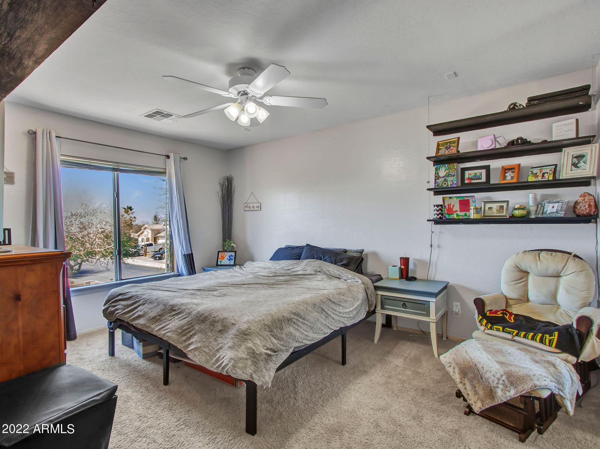 11645 West Mountain View Road Youngtown, AZ 85363 - Photo 25 of 45 a bedroom with a bed and a chandelier