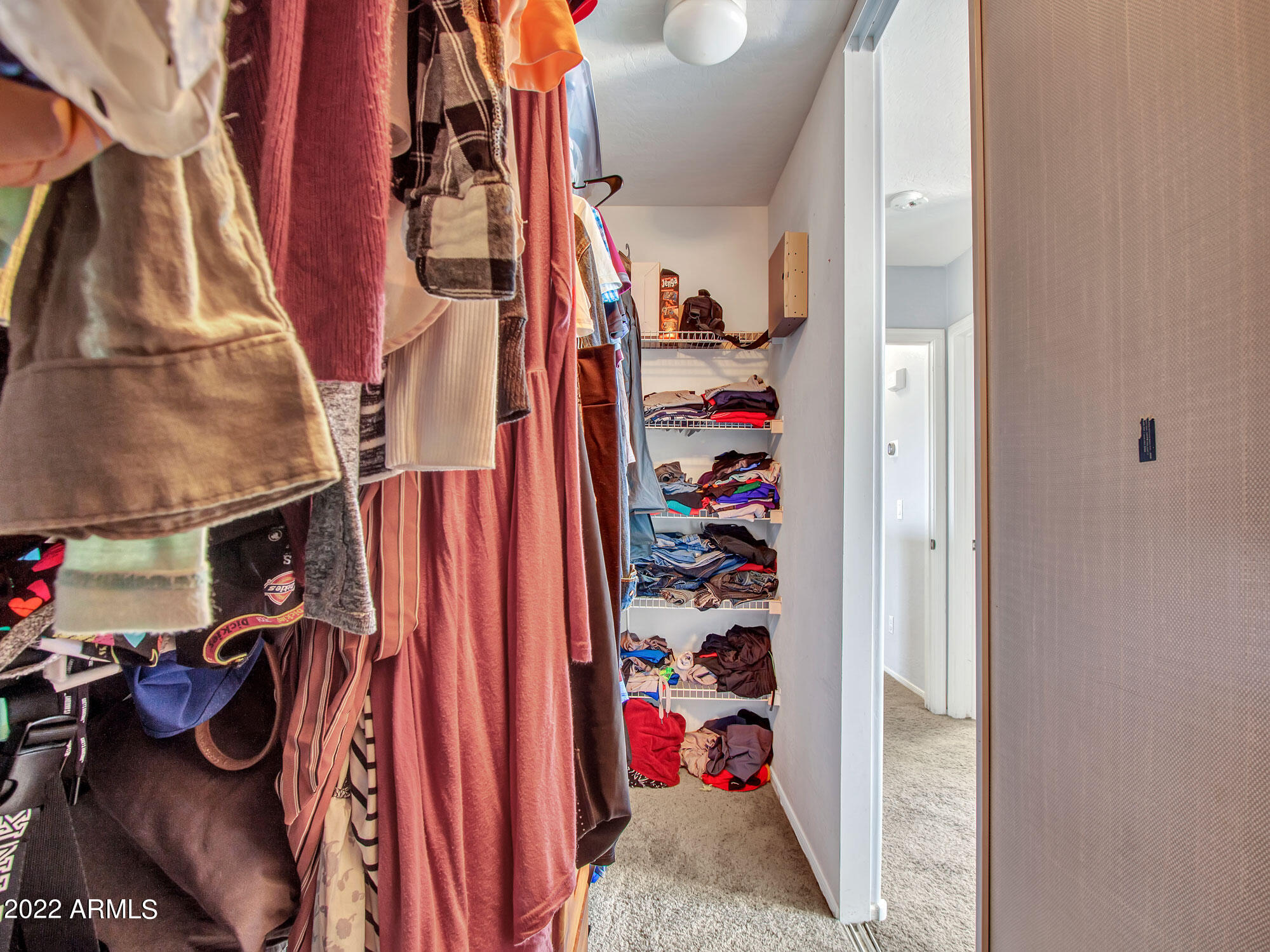 11645 West Mountain View Road Youngtown, AZ 85363 - Photo 28 of 45 a view of walk in closet with clothes and shoes