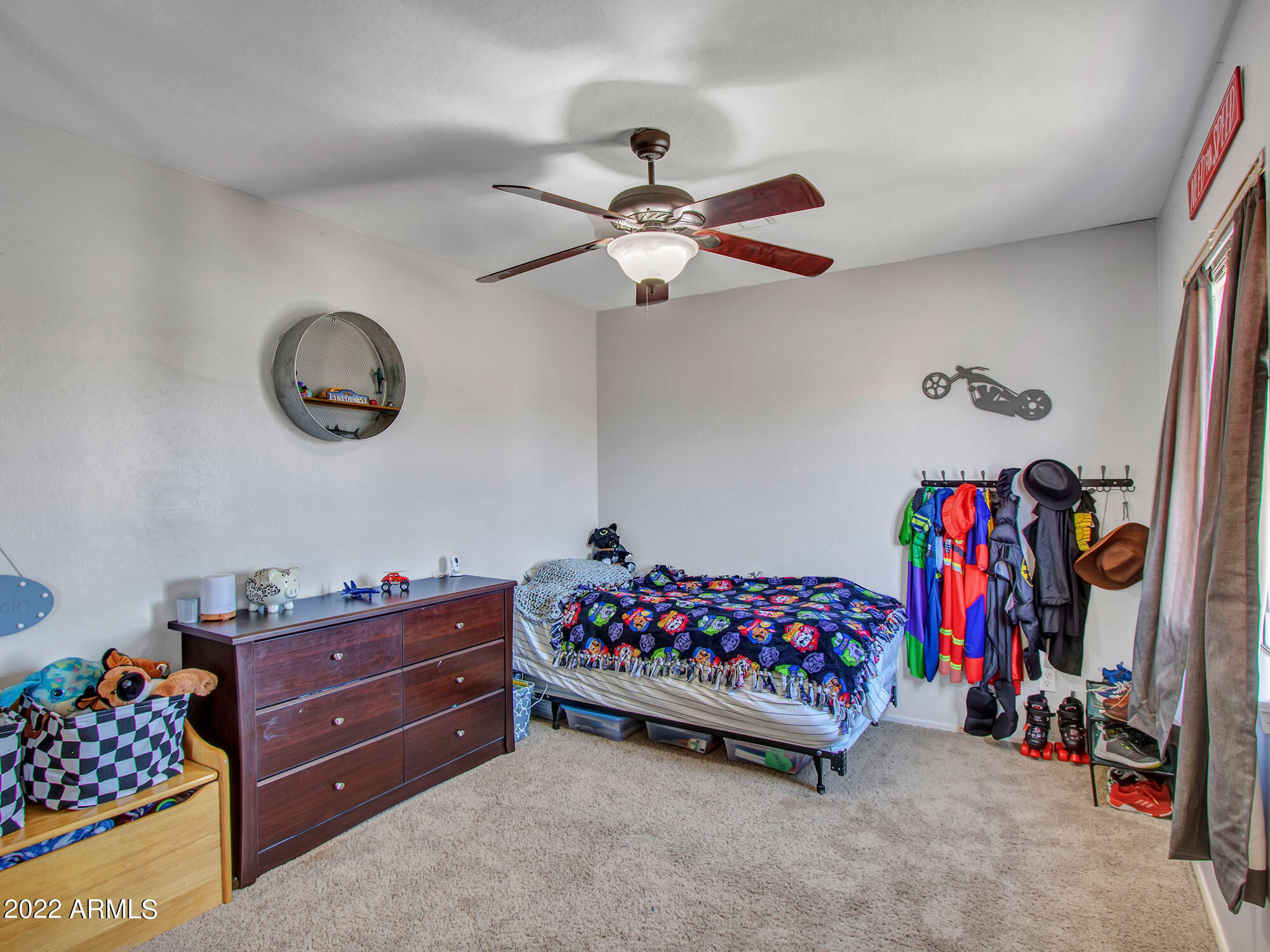 11645 West Mountain View Road Youngtown, AZ 85363 - Photo 33 of 45 a bed room with a bed and a ceiling fan