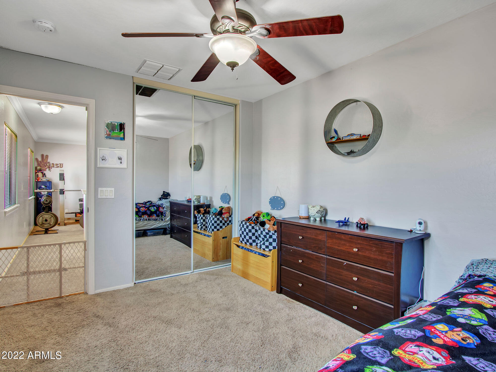 11645 West Mountain View Road Youngtown, AZ 85363 - Photo 34 of 45 a bedroom with a bed and a chandelier