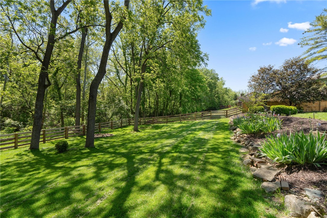 10168 Atchison Road Dayton, OH 45458 - Photo 7 of 44 This spacious yard features lush green grass, mature trees, and a charming wooden fence.