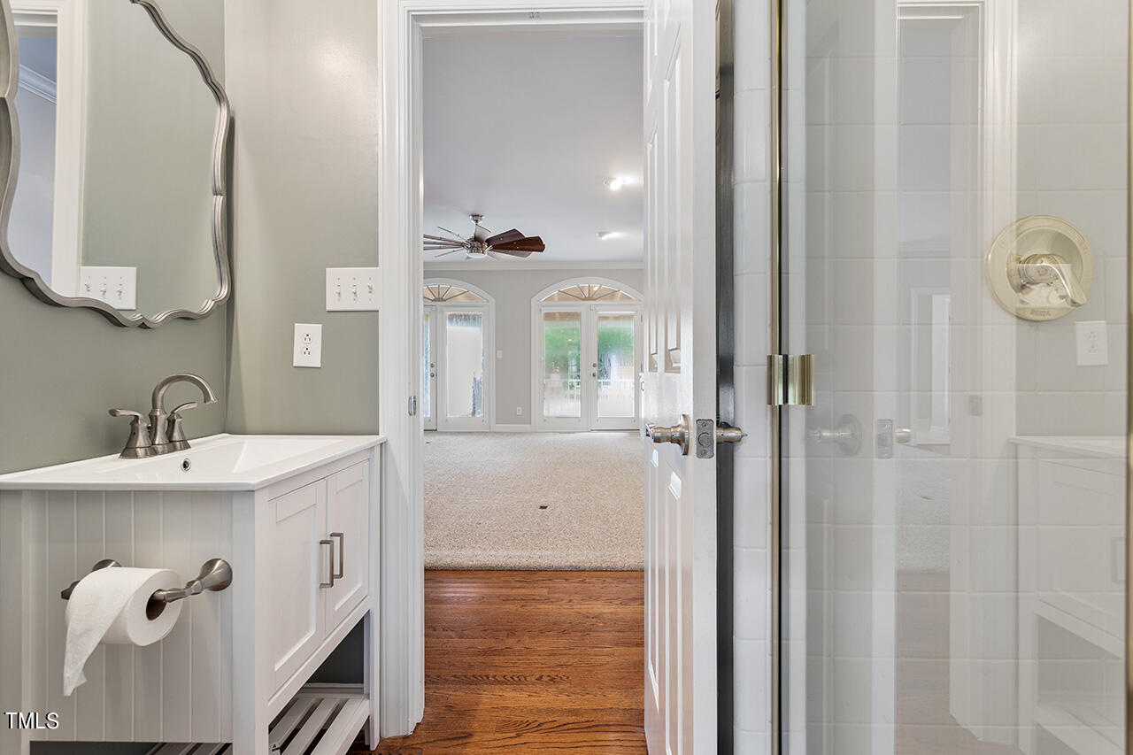 909 Rockfall Court Raleigh, NC 27614 - Photo 16 of 38 a bathroom with a sink a mirror and a shower