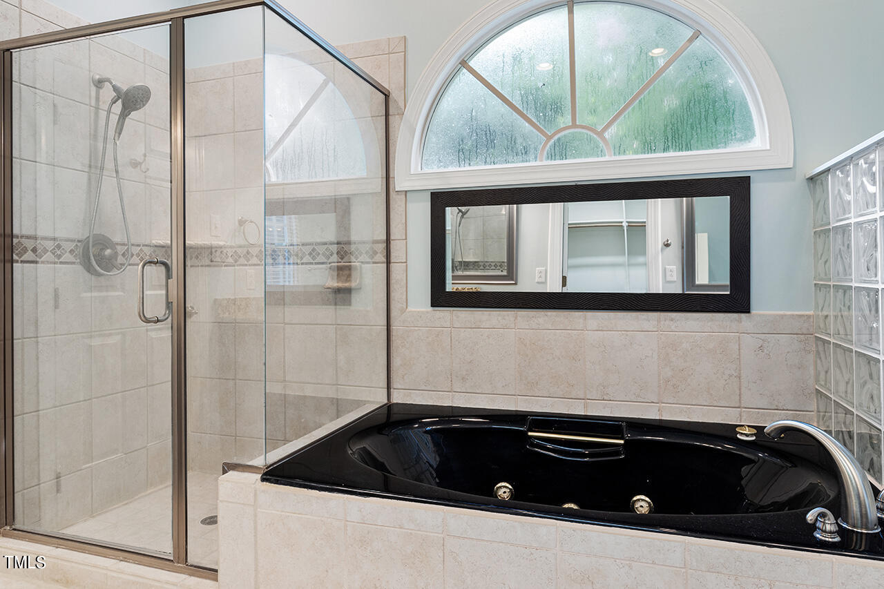 909 Rockfall Court Raleigh, NC 27614 - Photo 20 of 38 a bathroom with a bathtub and a window