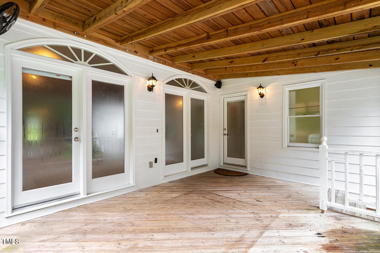 909 Rockfall Court Raleigh, NC 27614 - Photo 29 of 38 a view of a porch with a wooden door