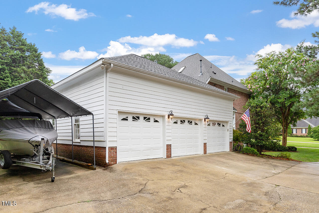 909 Rockfall Court Raleigh, NC 27614 - Photo 35 of 38 a view of a house with a backyard and a garage