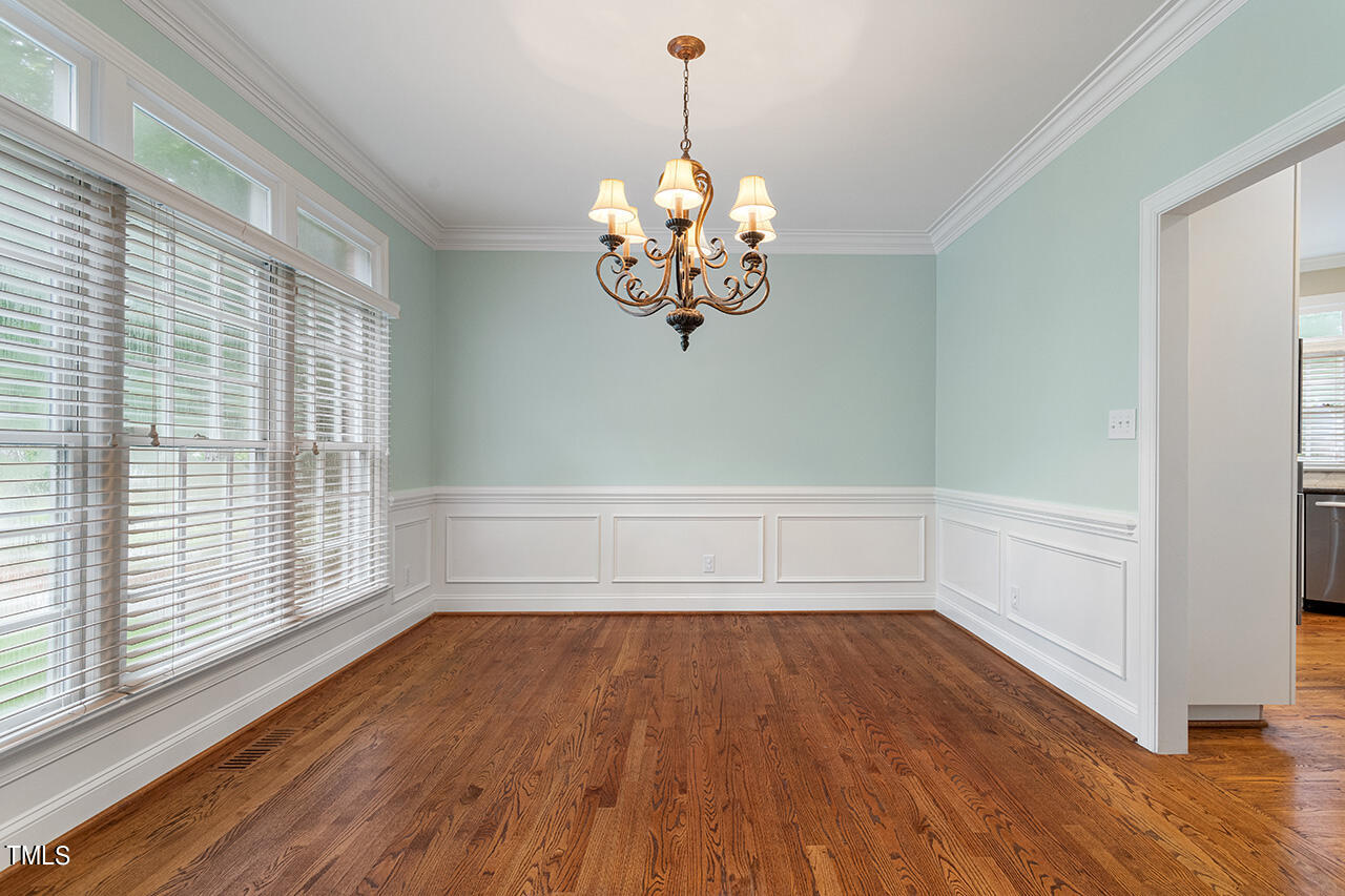 909 Rockfall Court Raleigh, NC 27614 - Photo 5 of 38 a view of a room with wooden floor and large windows