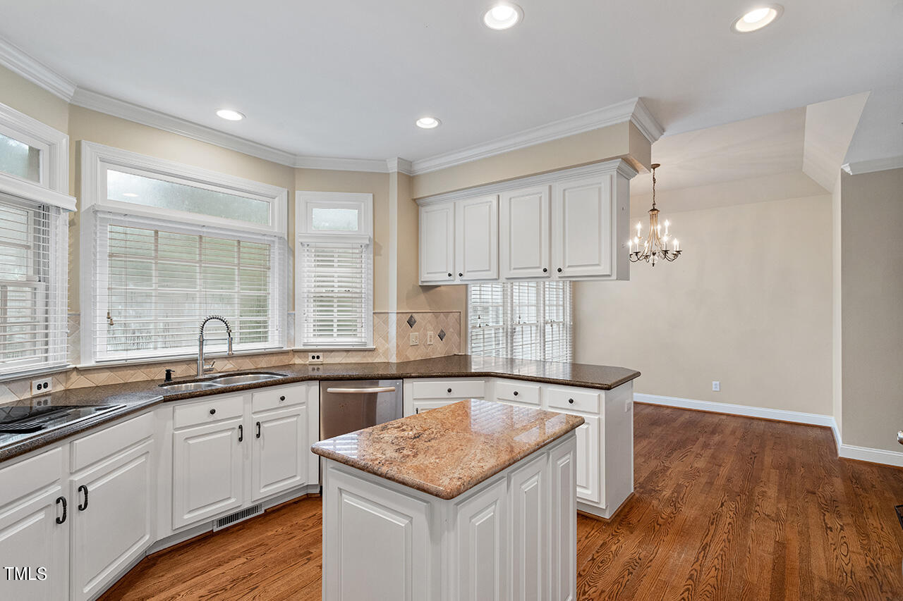909 Rockfall Court Raleigh, NC 27614 - Photo 6 of 38 a kitchen with a sink stove and cabinets