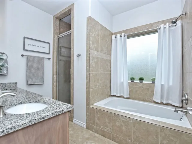 a spacious bedroom with a bed and a ceiling fan