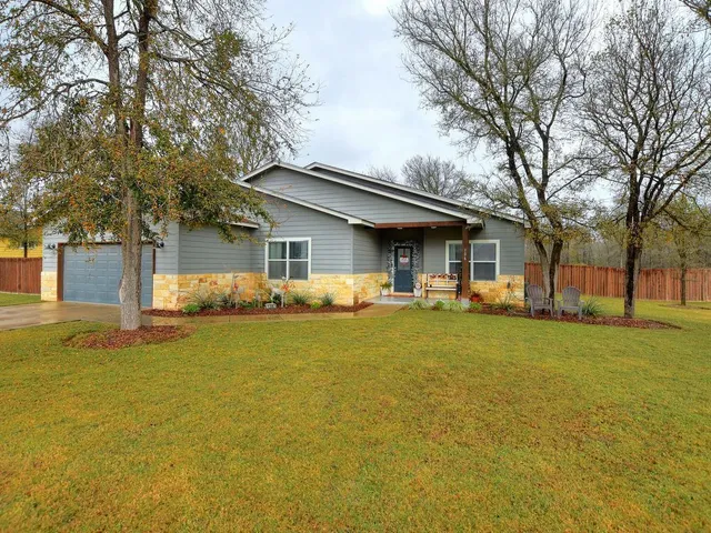 a front view of house with yard and trees