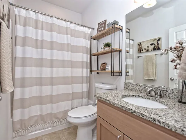 a living room with hard wood floor furniture and a chandelier