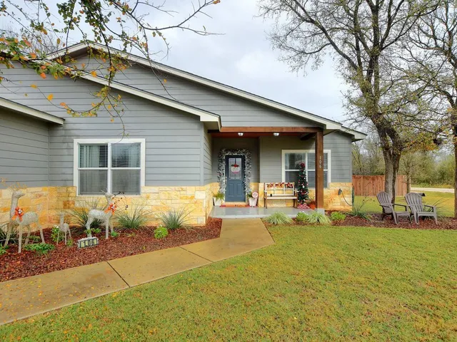a front view of a house with garden and porch