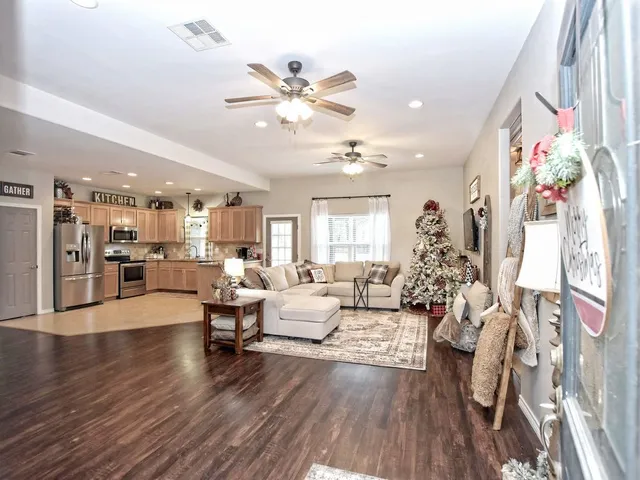 a living room with furniture and wooden floor