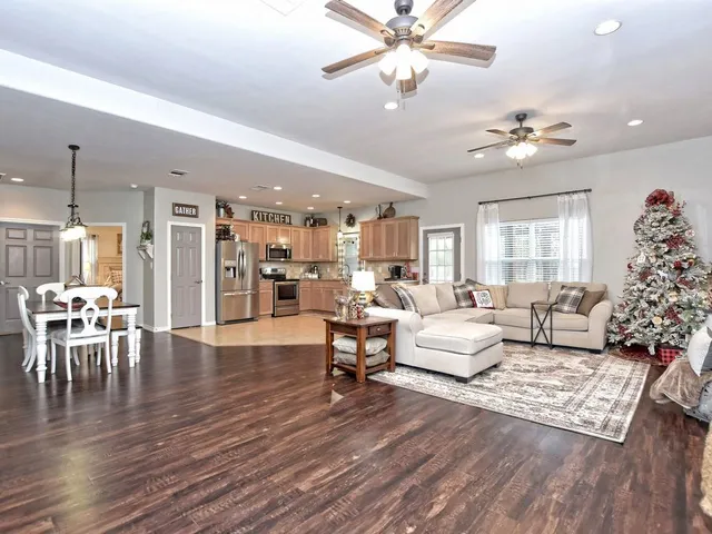 a living room with furniture and a chandelier