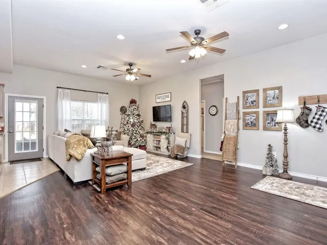 a living room with furniture and wooden floor