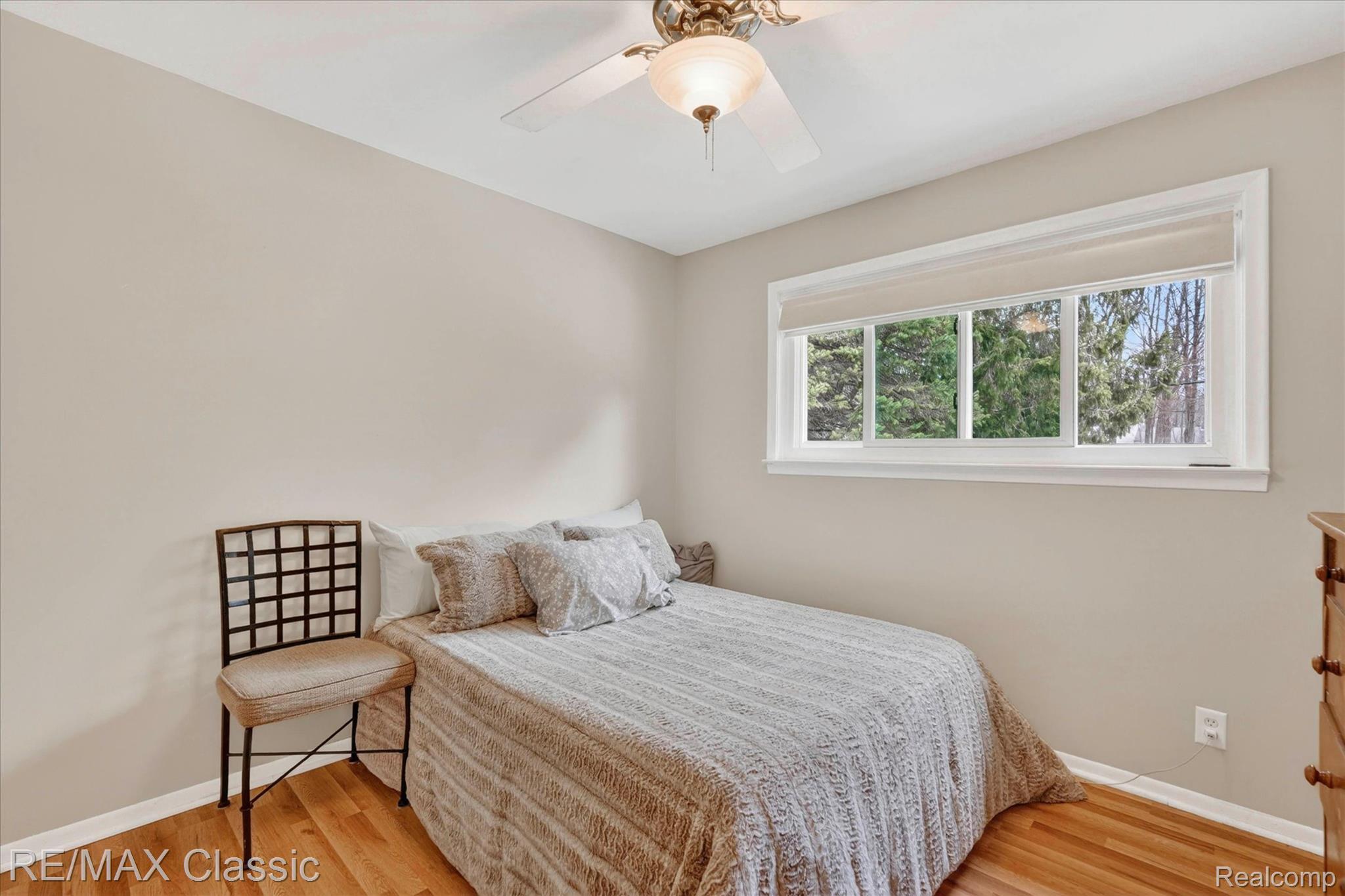 5060 Warmbriar Road White Lake, MI 48383 - Photo 14 of 34 Bedroom featuring light wood-type flooring and a ceiling fan