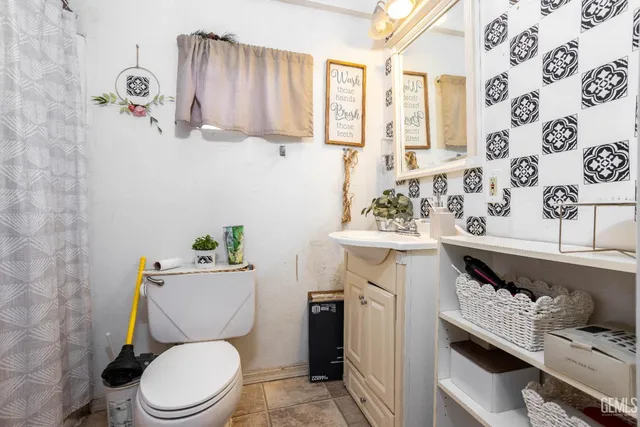 a bathroom with a toilet sink and mirror