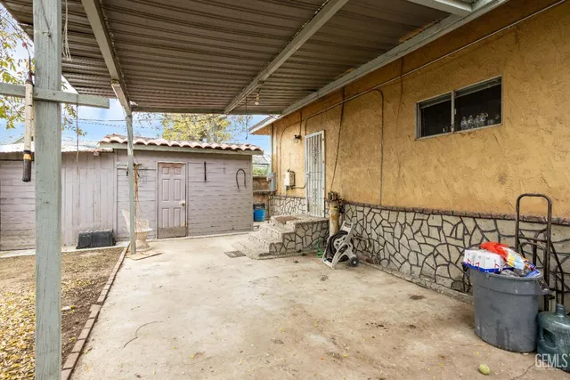 a view of a backyard with wooden fence