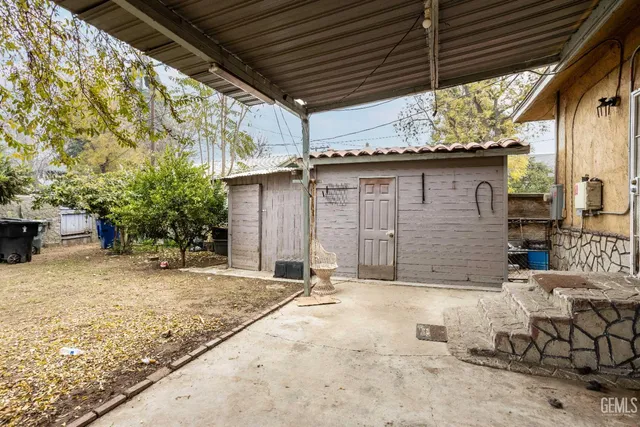 a view of backyard with a wooden fence