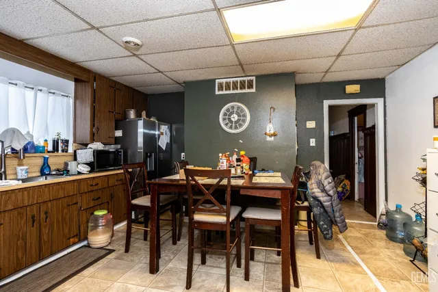 a view of a dining room and kitchen with furniture and a clock