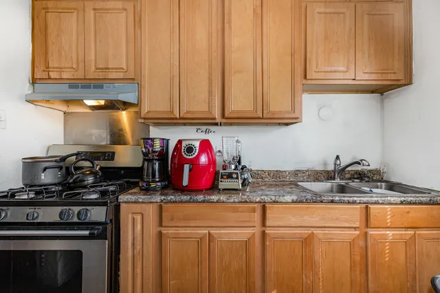 a kitchen with granite countertop cabinets and stainless steel appliances